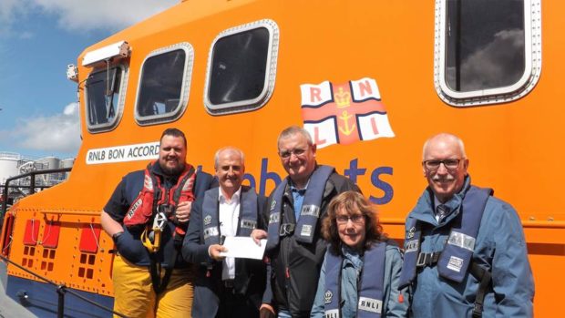 Gary Holman (centre left), vice chair of the International Association of Drilling Contractors (IADC) North Sea Chapter presents the £6,500 donation to Bill Deans MBE, Aberdeen lifeboat operations manager (centre right), with Aberdeen Lifeboat 2nd coxswain/mechanic Cal Reed (left), IADC administrator Edith McLeod and IADC North Sea director Derek Hart (right) looking on.